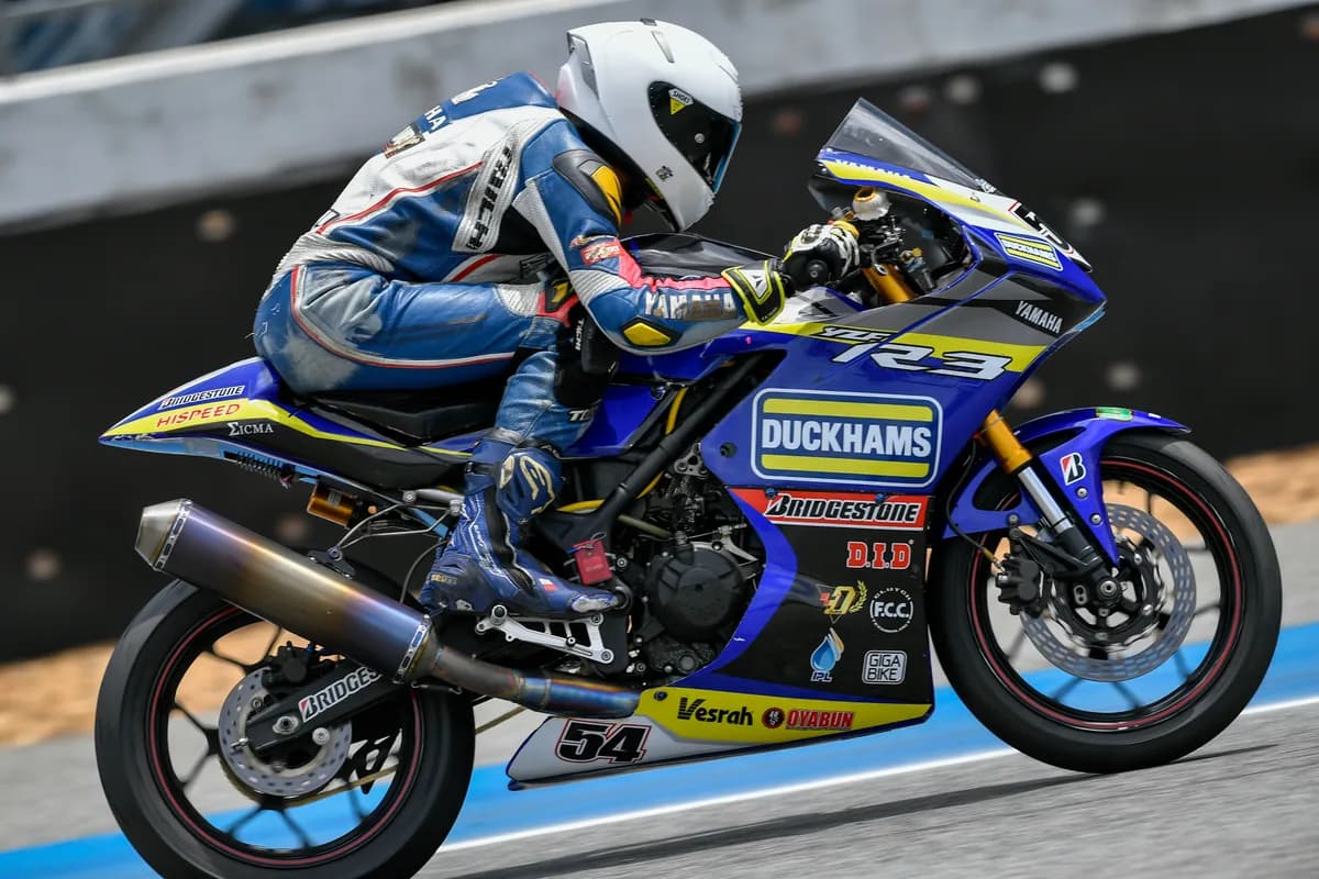 A rider on the Duckhams-liveried R3 superbike, leaned into a corner.